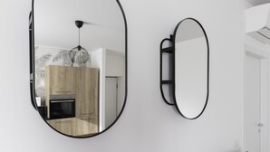 A modern kitchen with wooden cabinets, a built-in oven, and a pendant light. - Italianway Comfort - Buenos Aires 65 E (Milan)