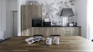 A modern kitchen with wooden cabinets, a microwave, and a coffee maker on the counter. - Italianway Comfort - Buenos Aires 65 E (Milan)
