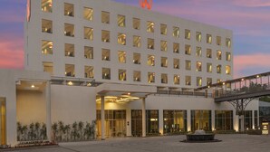 A modern hotel with a flat facade, multiple windows, and a prominent logo at the top. - Welcomhotel By ITC Hotels Belagavi (Belagavi)