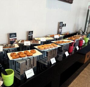 A buffet with various baked goods like muffins, donuts, and pastries. - Welcomhotel By ITC Hotels Belagavi (Belagavi)