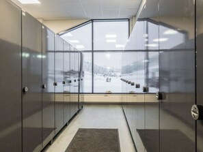 A glass-walled office cubicle with a view of a snowy outdoor area.