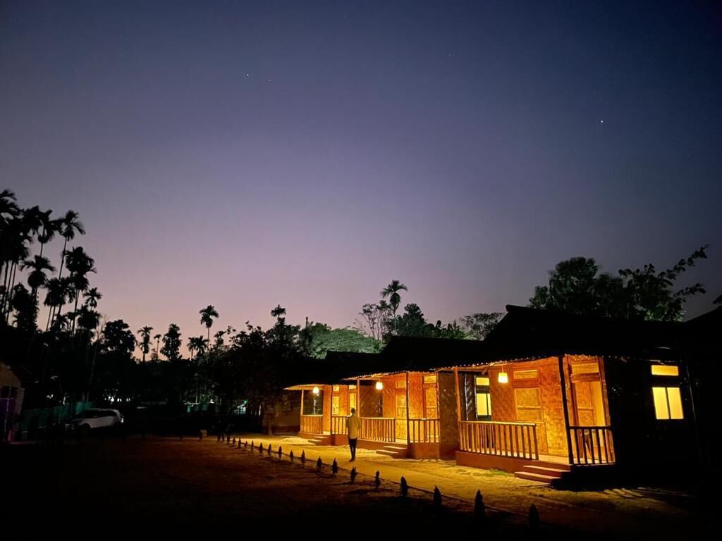 A building with multiple rooms, a porch, and a fenced area.
