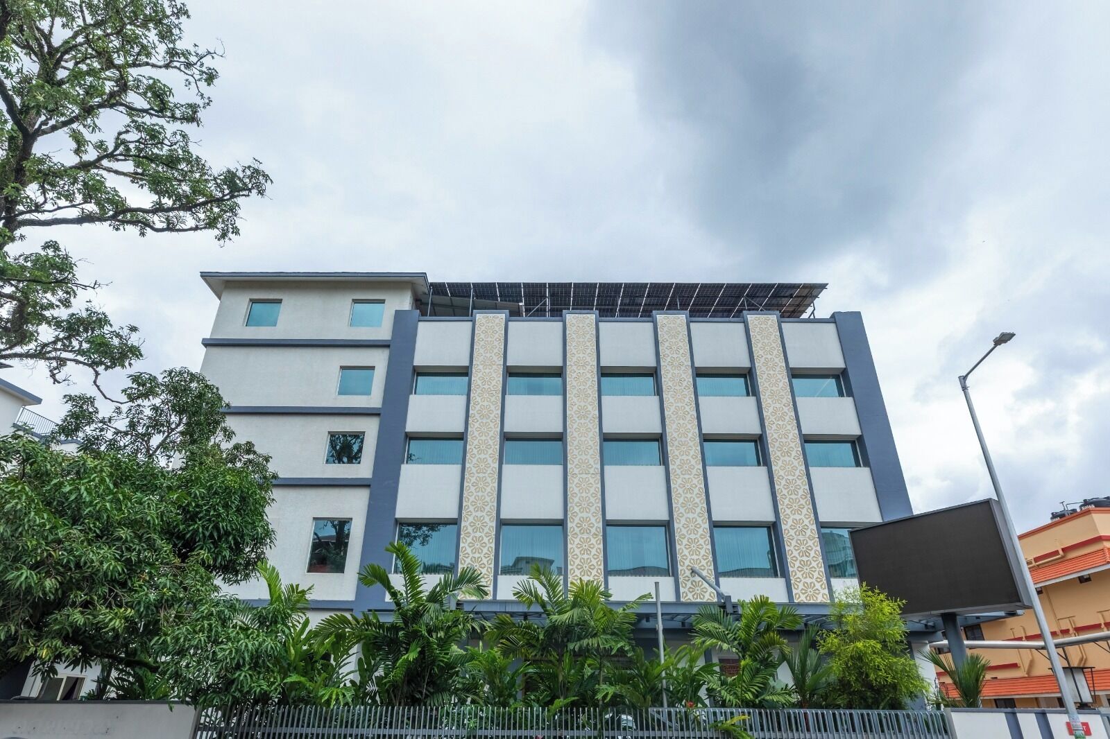 A modern building with multiple floors, large windows, and a patterned facade.