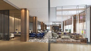 A spacious lobby with high ceilings, wooden columns, and a mix of seating areas including sofas and chairs. - PARKROYAL A'Famosa Melaka Resort (Alor Gajah)
