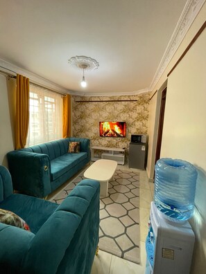 Business Apartment | Living area | 24-inch Smart TV with digital channels - Lux Suites Nila Apartments Utawala (Nairobi)