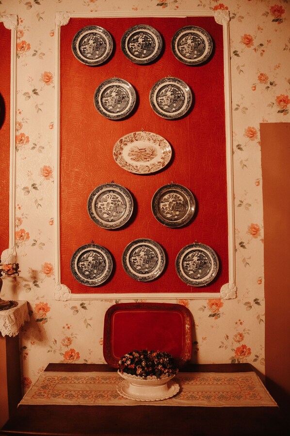 A wall with nine plates arranged in a grid pattern.