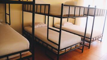 Habitación tipo dormitorio con literas dispuestas en dos filas.