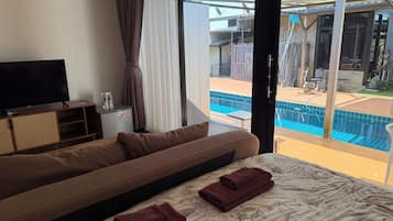 Luxury Room, Pool View | Minibar, in-room safe, individually decorated, individually furnished