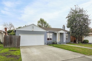 A single-story house with a garage, a front porch, and a well-maintained lawn. - @ Marbella Lane - Immaculate & Cozy 3BR Home (San Jose)