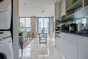 Una cocina moderna con comedor, ventanas amplias y vistas a la ciudad.