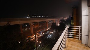A night view from a balcony overlooking a busy highway with multiple lanes and vehicles. - Hotel Lyf Corporate Suites - Peera Garhi (New Delhi)