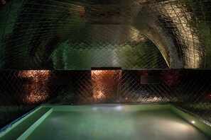 An indoor swimming pool with a netted enclosure and a central light fixture. - Palazzo Talìa - Small Luxury Hotels of the World (Rome)