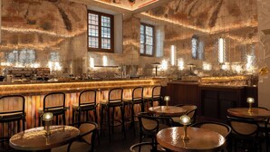 A bar area with multiple seating arrangements and a decorative ceiling. - Palazzo Talìa - Small Luxury Hotels of the World (Rome)