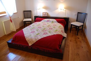 Cozy retreat with a comfortable bed, two chairs, and a nightstand.