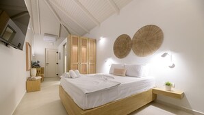 Een moderne slaapkamer met een houten bed, witte beddengoed, een nachtkastje met een plant en twee wandlampen.