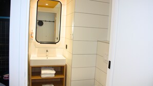 A compact bathroom with a white sink, mirror, and toilet. - Aparthotel Adagio Access Porte De Camargue (Saint-Martin-de-Crau)