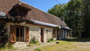A stone house with a tiled roof, wooden shutters, and a stone pathway leading to the entrance. - Charming Cottage with Private Heated Pool, Fitness Room, Game Room, Near Rillé Lake (Rillé)