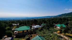 A rural village with houses and greenery. - Hotel JK Dharamshala (Dharamshala)