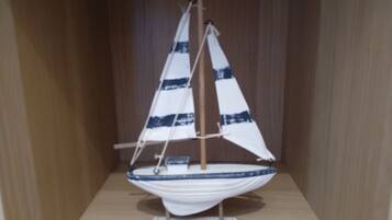 A model sailboat in a wooden display case.