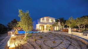 A modern two-story house with a swimming pool, stone pathway, and outdoor seating area. - BRAND NEW, SECLUDED VILLA WITH PRIVATE POOL AND AMAZING VIEW, CLOSE TO THE TOWN. (Rethimno)