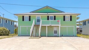 A two-story house with a front porch and a number '129' on the door.