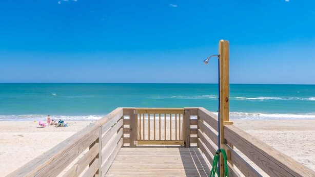 A wooden boardwalk leading to a beach with a clear view of the ocean. - Sea Glass - Fantastic Views from this 3 BR Oceanfront Home! (Surf City)