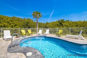 A swimming pool with a palm tree and green chairs. - Wells Beach Paradise - Awesome 5BR Home - Pool, Hot Tub, Great Ocean Views! (North Topsail Beach)