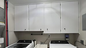 A laundry room with two washing machines, a drying rack, and a ceiling light fixture. - Newly Remodeled Monthly Special!!  2 Bd/1Bath Home! (Parma Heights)