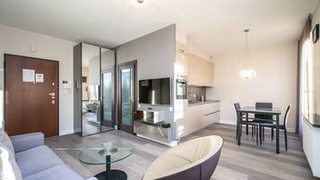 Comfort Apartment | Living area | 37-inch flat-screen TV with satellite channels, streaming services