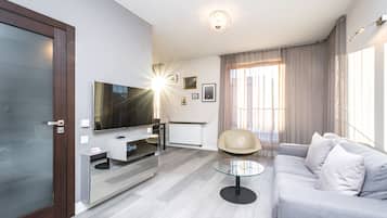 Comfort Apartment | Living area | 37-inch flat-screen TV with satellite channels, streaming services