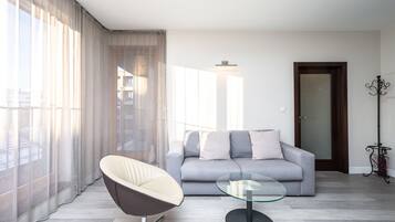 Comfort Apartment | Living room | 37-inch flat-screen TV with satellite channels, streaming services