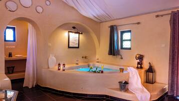 Relax in a spacious bathroom with a bathtub and shower area.