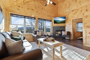 Signature Cabin, Multiple Bedrooms, Hot Tub, River View | Living room | 65-inch Smart TV with cable channels, fireplace