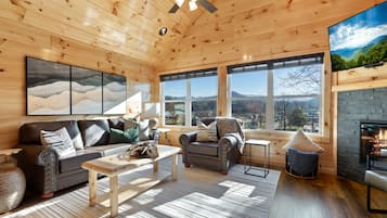 Signature Cabin, Multiple Bedrooms, Hot Tub, River View | Living room | 65-inch Smart TV with cable channels, fireplace