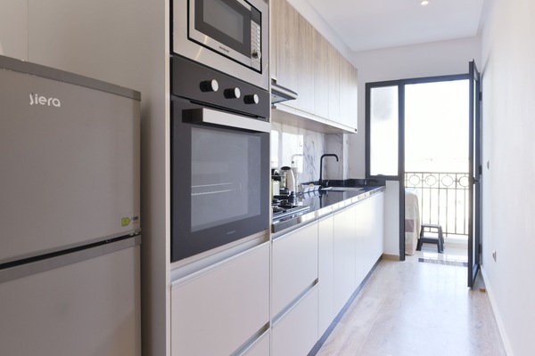 Deluxe Apartment, Multiple Beds, Balcony, City View | Private kitchen | Full-size fridge, microwave, oven, stovetop