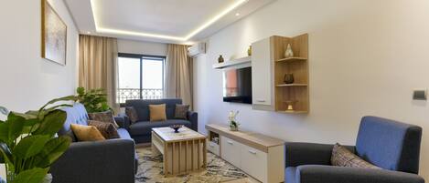 Deluxe Apartment, Multiple Beds, Balcony, City View | Living area | 55-inch Smart TV with satellite channels, Netflix, first-run movies