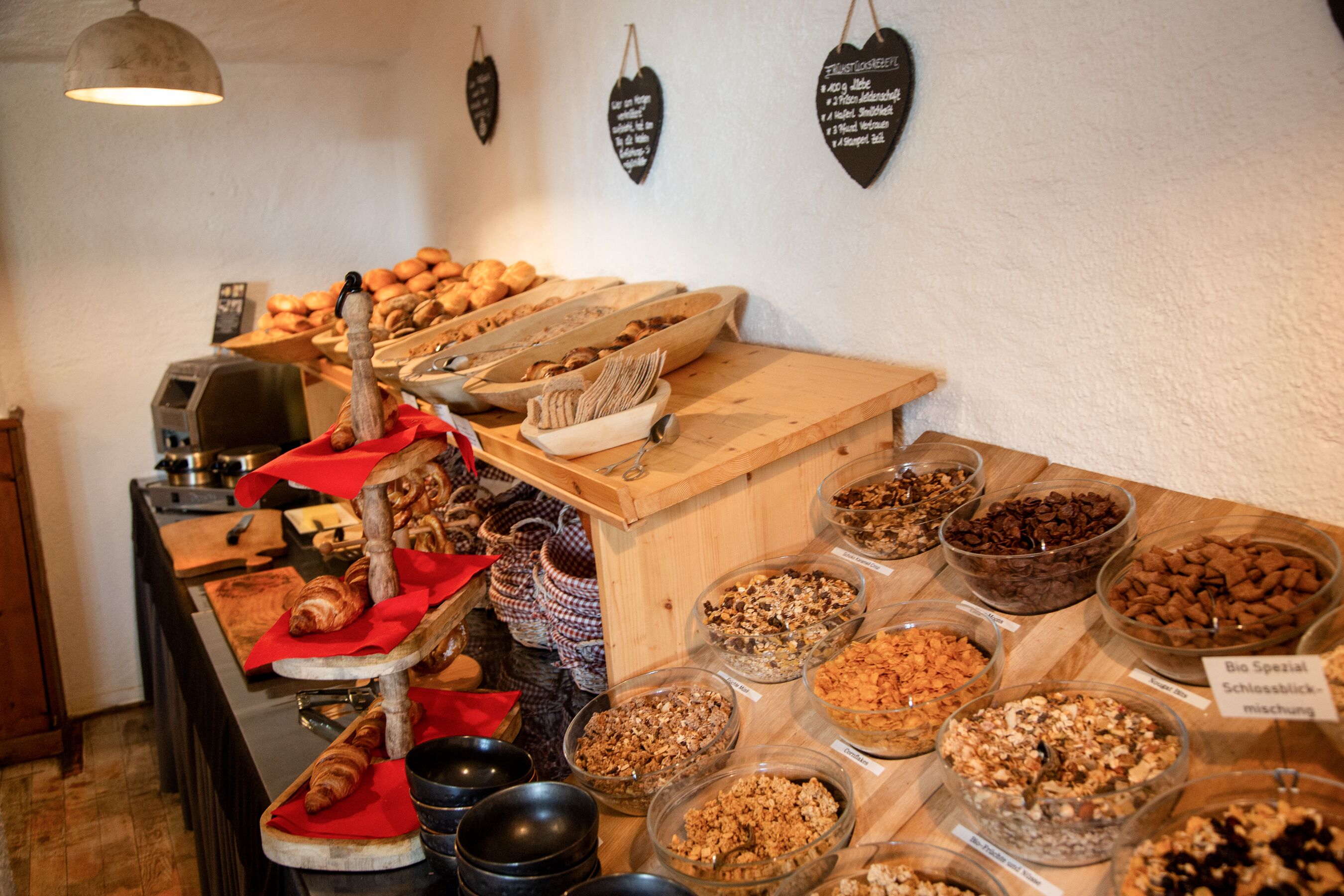 A buffet with various food items and a wooden counter.