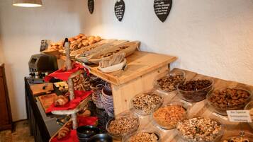 A buffet with various food items and a wooden counter.
