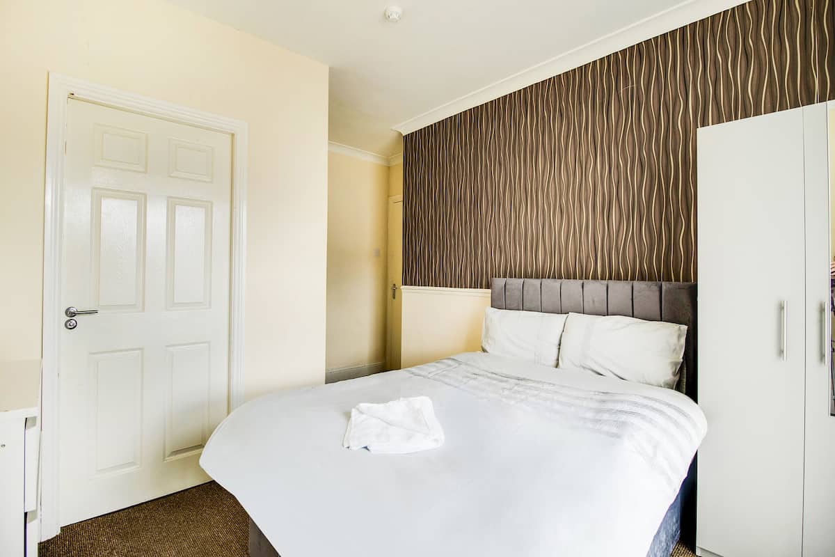 Desk, iron/ironing board, bed sheets