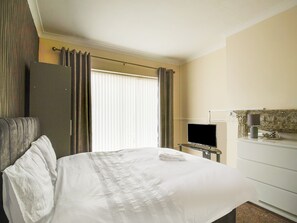 Desk, iron/ironing board, bed sheets