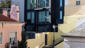 A multi-story building with balconies and a staircase leading to the upper floors. - The Haus - Alegria (Lisbon)