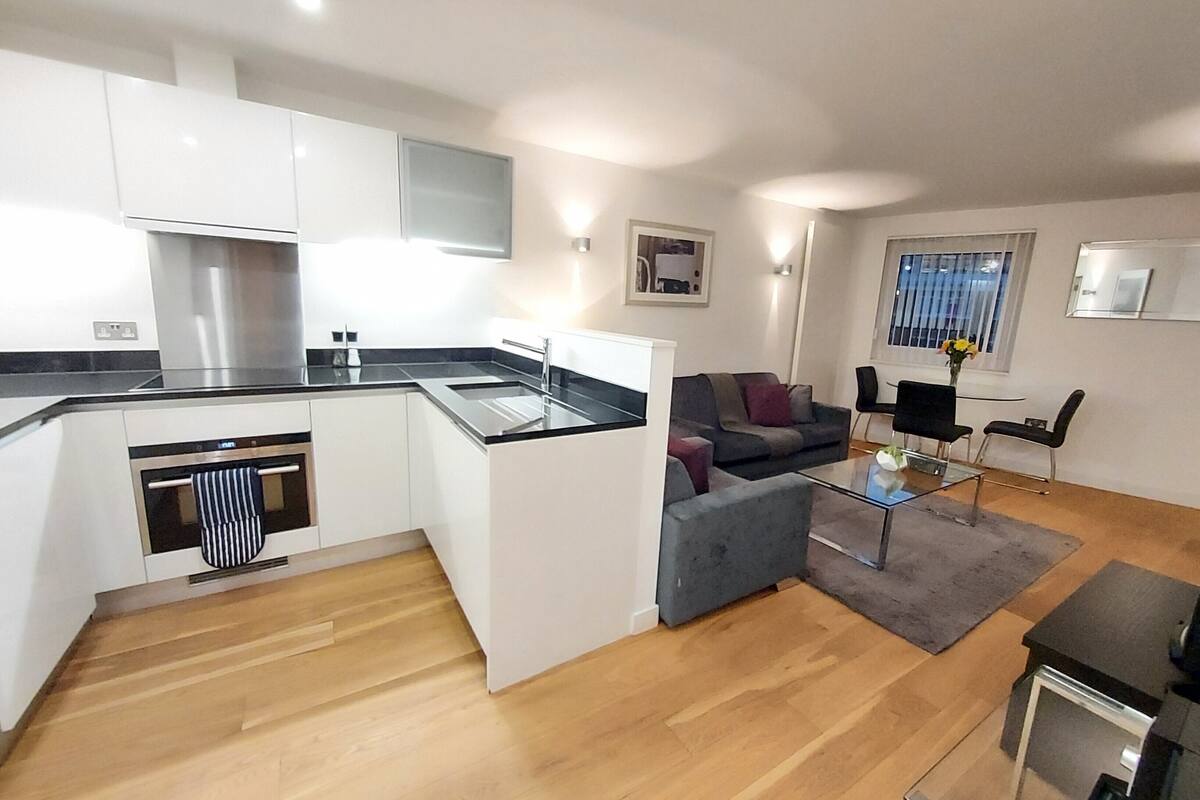 A modern apartment with a kitchen, living area, and a dining space.