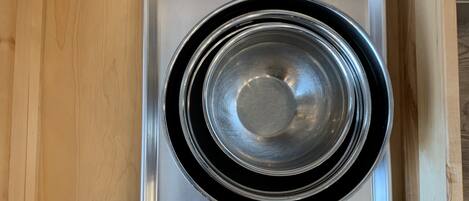 A stainless steel kitchen range hood installed in a wooden cabinet.
