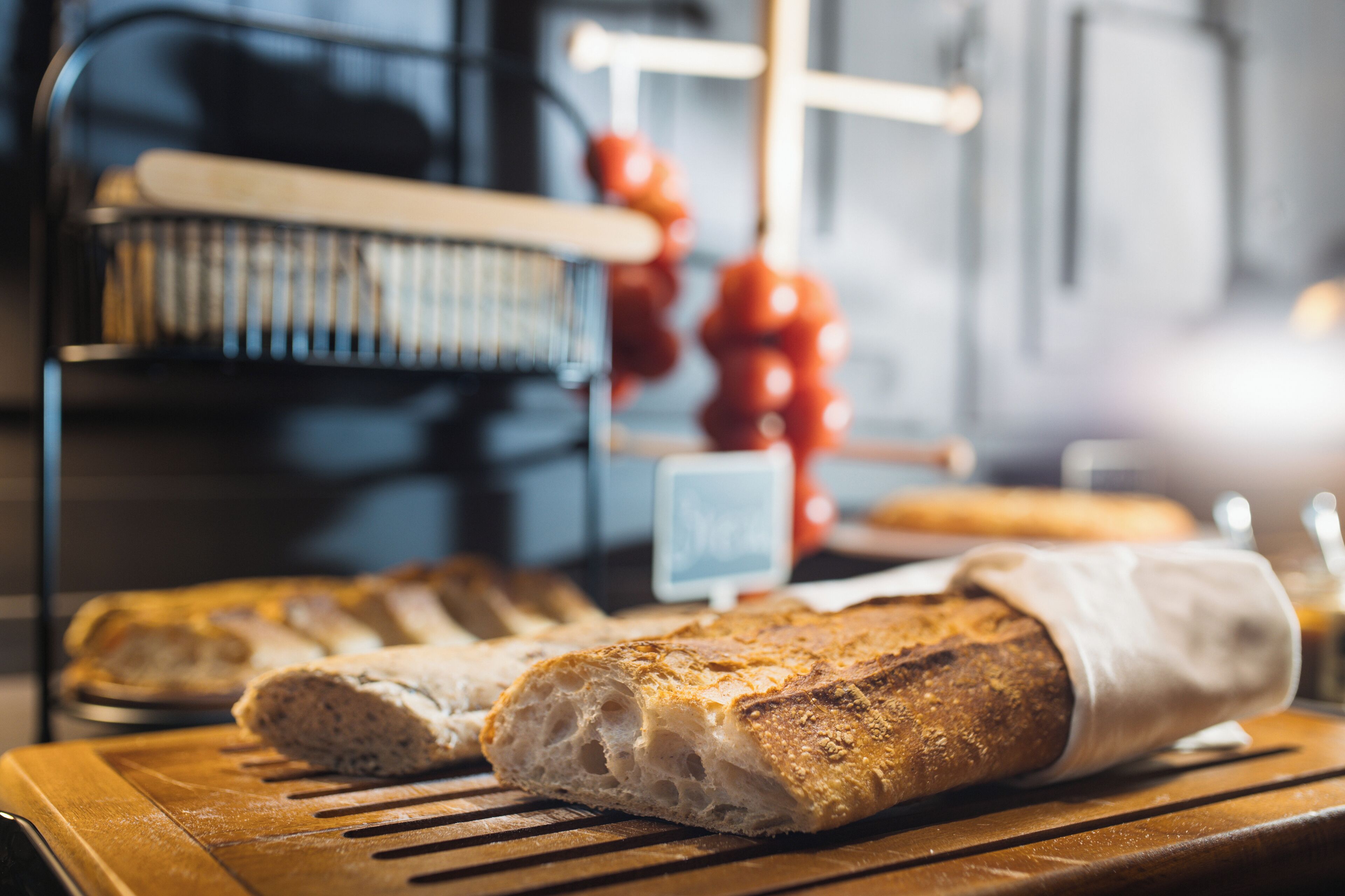 A loaf of bread on a wooden cutting board.