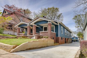 A two-story house with a front porch, brick foundation, and a blue exterior. - Extended Stays Welcome! Home 1 Block to Avondale (Birmingham)