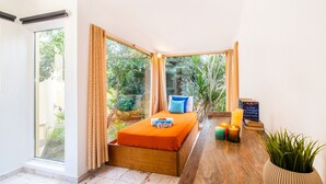 A bedroom with a bed, a window, curtains, a bedside table with candles, and a potted plant. - Peaceful villa with pool & BBQ (Albufeira)