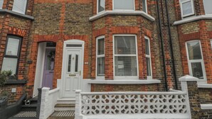 A corner house with a bay window, a white front door, and a small porch with a white balustrade. - 6 Sydney Road (Ramsgate)
