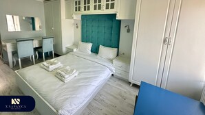 A hotel room with a bed, a desk, a chair, a wardrobe, and a skylight. - X SAPANCA OTEL (Sapanca)