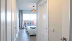A hallway with a bed, a balcony, and a door. - Casa Jsmina Calahonda With Seaview 2 bed 2 Bath (Sitio de Calahonda)