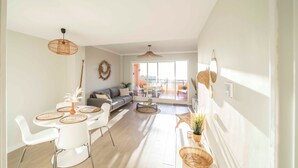 A modern living room with a dining area, a sofa, and a view of the outdoors. - Casa Jsmina Calahonda With Seaview 2 bed 2 Bath (Sitio de Calahonda)